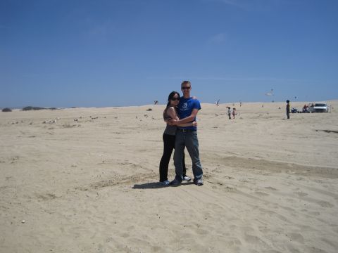 1989 Toyota Pickup/SR5 - Couple on a beach with a white SUV visible in the background.