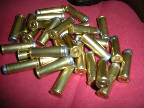 1996 Ford Bronco - A collection of spent ammunition casings is scattered across a red fabric surface.