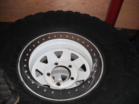 1991 Ford Bronco - A close-up view of an off-road tire and wheel assembly.
