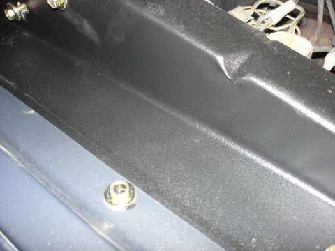 1979 Ford F-250 - Close-up view of engine bay components, including wiring and a textured plastic panel.