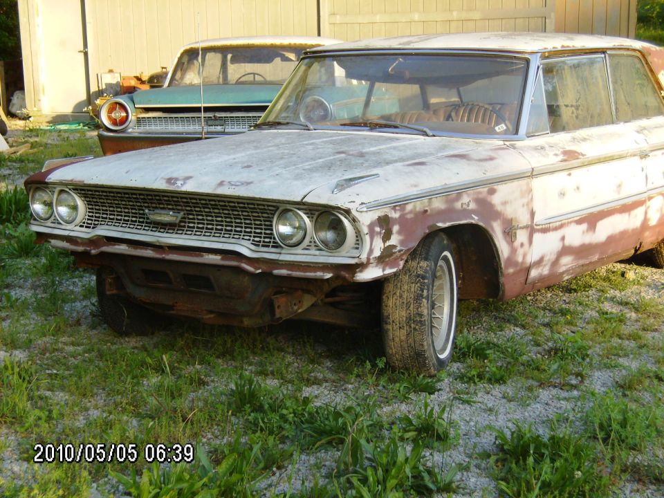 1963 Ford Galaxie front end with rust damage, parked next to another vintage car