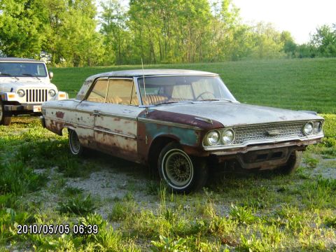 1963 Ford Galaxie - A weathered 1963 Ford Galaxie sits parked next to a Jeep on a sunny day.