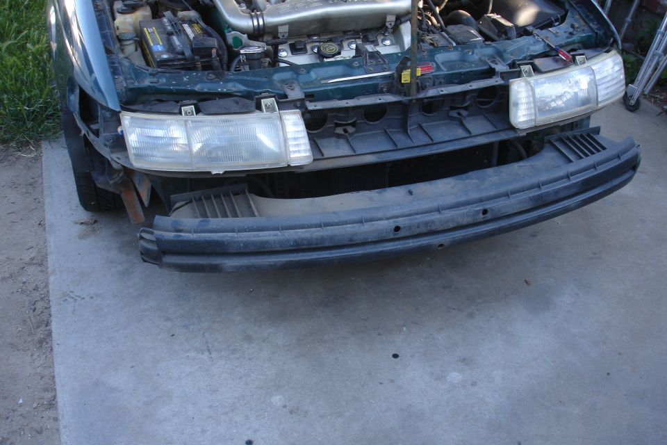 1993 Ford Taurus front end with bumper removed and engine visible