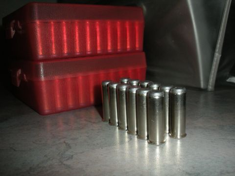 1996 Ford Bronco - Ammunition cartridges and two red plastic ammo storage boxes are shown on a surface.