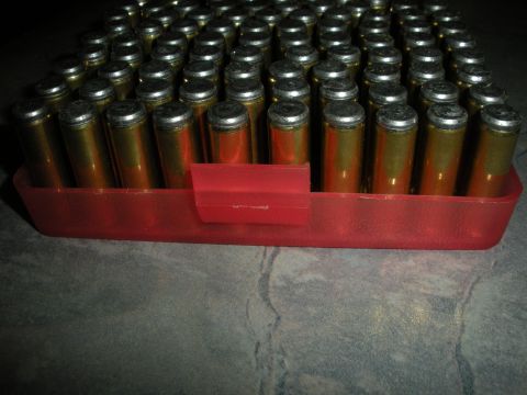 1996 Ford Bronco - A red plastic carrier holds rows of brass-cased ammunition.