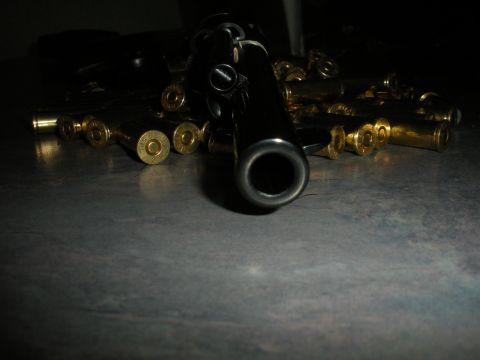 1996 Ford Bronco - A handgun and ammunition are displayed on a table, with the barrel prominently in the foreground.