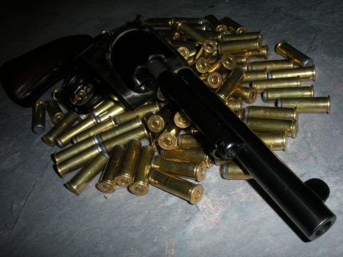 1996 Ford Bronco - A firearm and ammunition are displayed on a textured surface.