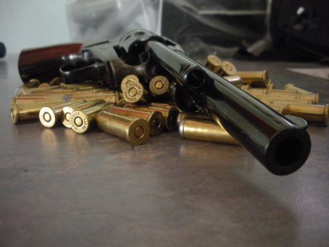 1996 Ford Bronco - A revolver and a pile of ammunition are displayed on a flat surface.