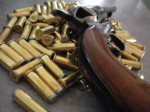 1996 Ford Bronco - A close-up view of a handgun and ammunition, with a watermark at the bottom right.