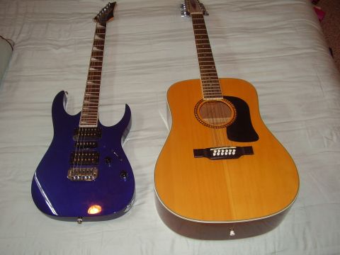 1996 Ford F-150 - A blue electric guitar and a 12-string acoustic guitar are displayed side-by-side on a white, textured surface.