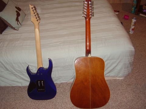 1996 Ford F-150 - A blue electric guitar and a brown acoustic 12-string guitar are shown on a bed.