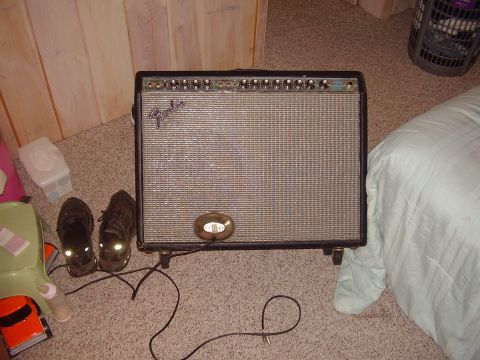1996 Ford F-150 - A Fender amplifier is visible in a room with wood-paneled walls and carpeted floor.