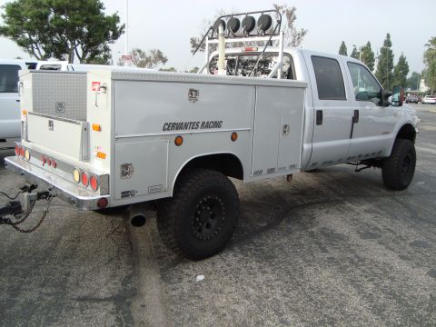 1986 Ford Bronco - This truck features a custom service body with multiple compartments and a trailer hitch.