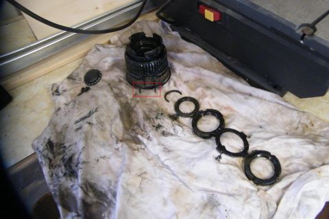1989 Ford Bronco - In the middle of the hub is the grease cover. Pull that off. It's the little piece in the upper left. The pieces coming out go in order fro…