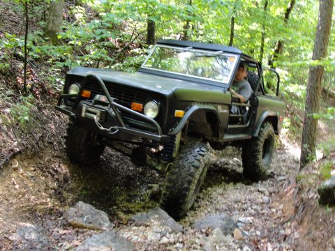 1967 Ford Mustang - A first-generation Ford Bronco tackles a challenging rocky trail, demonstrating its off-road capabilities.