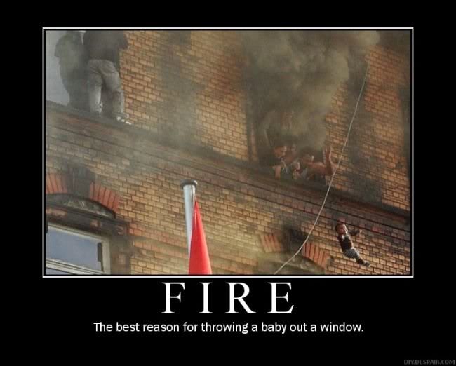 People escaping a building fire via a rope, with smoke billowing from windows