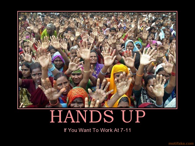 Crowd of people with hands raised, some wearing headscarves