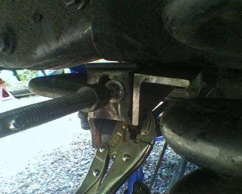 1987 Ford Bronco - A mechanic uses vise grips on a vehicle's suspension system during a repair.