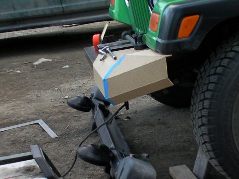1987 Suzuki Samurai - Cardboard mockup is taped to the front bumper of a green Jeep Wrangler.