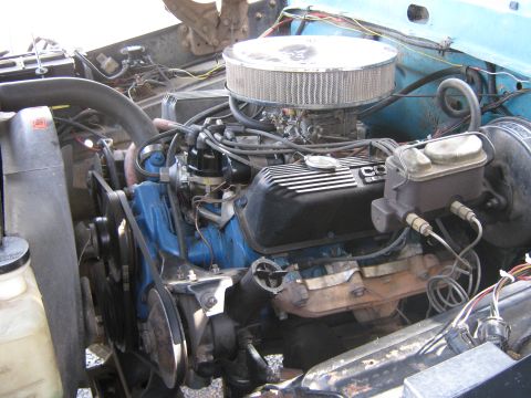 1972 Ford F-250 - The engine bay of a vehicle shows a Ford V8 engine with a prominent air filter and carburetor assembly.