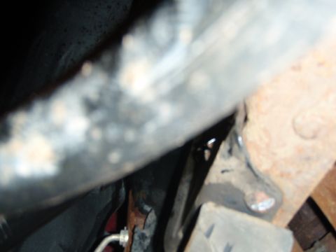 1995 Ford Bronco - Close-up view of rusty vehicle frame and suspension components with Supermotors.net logo.