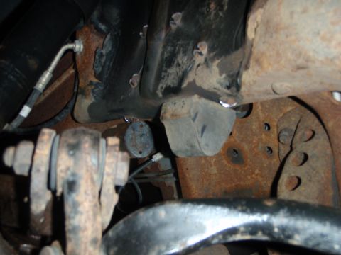 1995 Ford Bronco - This image shows a close-up view of heavily rusted vehicle suspension components, likely from underneath a truck or SUV.