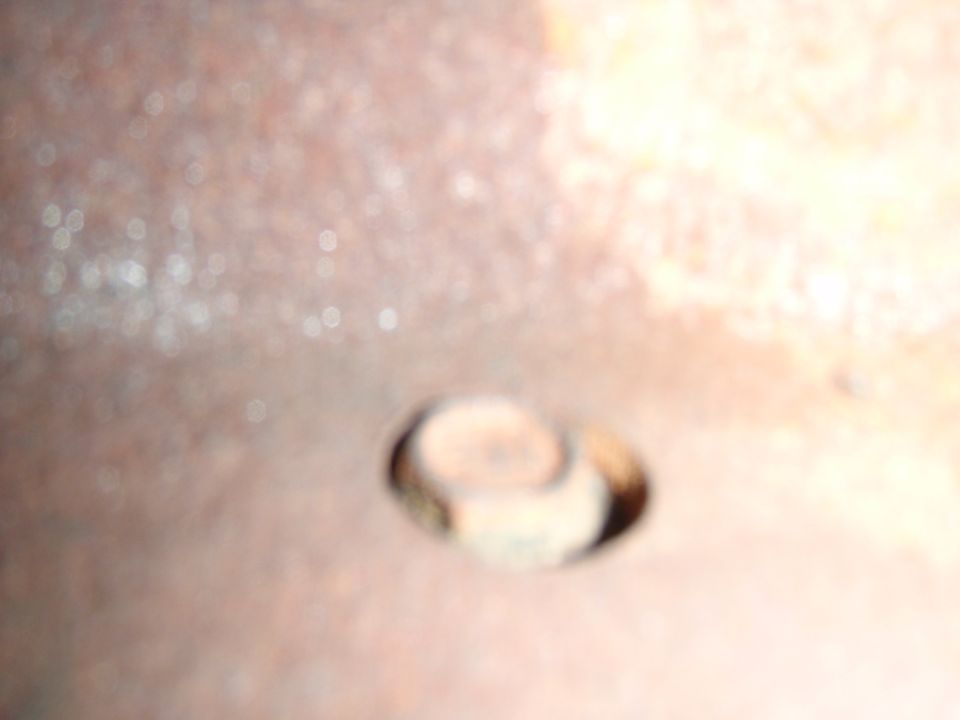 Rusty metal surface with a bolt head visible