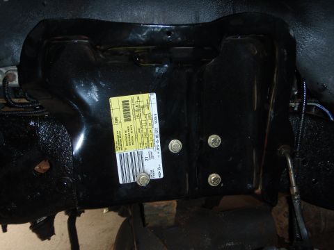 1995 Ford Bronco - Vehicle part with a yellow sticker containing text and a barcode.