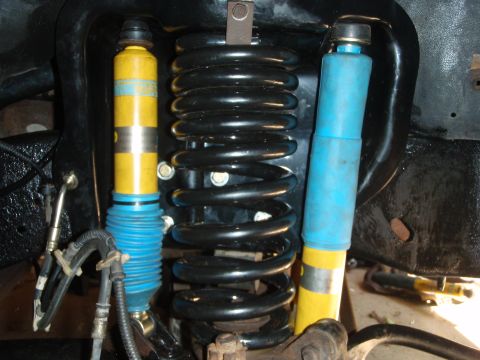 1995 Ford Bronco - Close-up view of vehicle suspension components, including shock absorbers and coil springs.