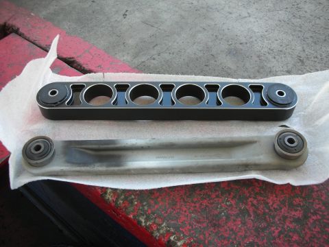 2004 Ford Crown Victoria - Comparison of a new aftermarket control arm and an old OEM control arm.