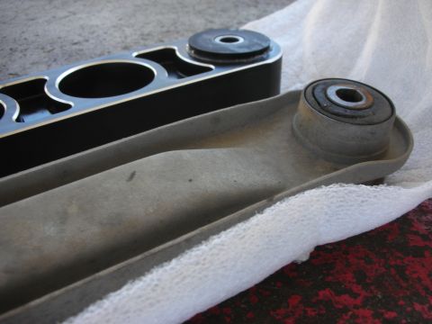 2004 Ford Crown Victoria - Two control arms, one new and one old, are shown side-by-side for comparison.