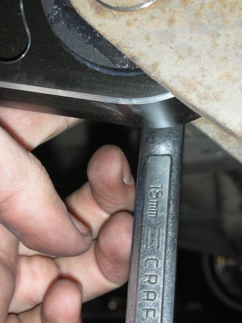 2004 Ford Crown Victoria - Using an 18mm wrench to tighten a bolt on a vehicle's suspension component.
