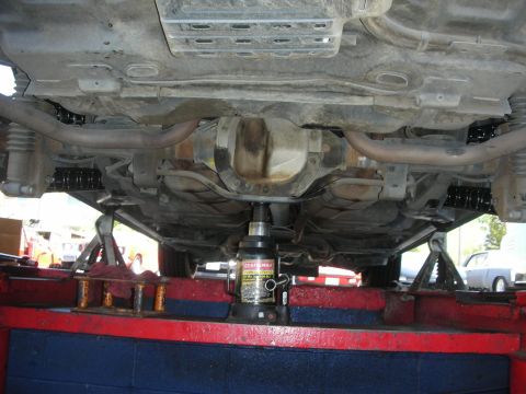 2004 Ford Crown Victoria - The underside of a vehicle is shown, with the rear axle and exhaust system clearly visible.