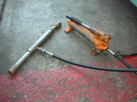2004 Ford Crown Victoria - Tools for automotive repair are laid out on a workshop floor.