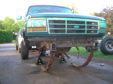 1996 Ford Bronco - This Ford truck is undergoing modifications, with its front suspension components removed and laid out.