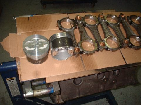 1969 Ford Torino - Engine components, including pistons and connecting rods, are arranged on a piece of cardboard.