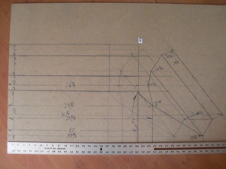 Photo of a hand-drawn dimensioned layout on cardboard with a ruler