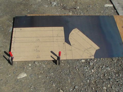 1987 Suzuki Samurai - A paper template with measurements and lines is placed on a dark metal sheet, secured by red-tipped clamps.