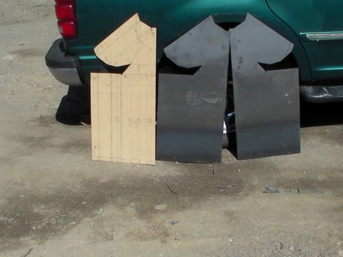 1987 Suzuki Samurai - Cardboard template and two cut mud flaps are positioned near the rear bumper of a green SUV.