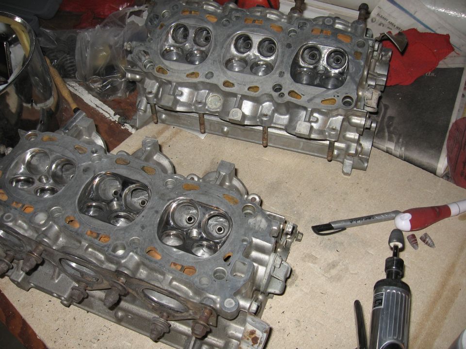 Engine cylinder heads on a workbench with tools