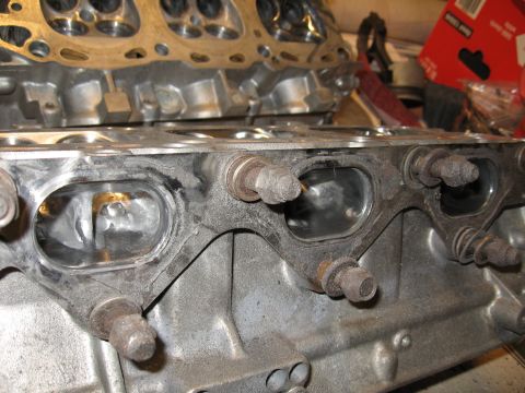 1991 Mitsubishi 3000GT - Engine cylinder head ports shown in detail, with visible bolts and gasket remnants.