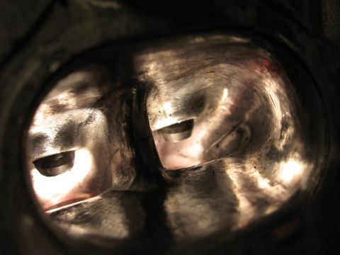 1991 Mitsubishi 3000GT - Close-up view inside the intake ports of an engine cylinder head, revealing the valves.