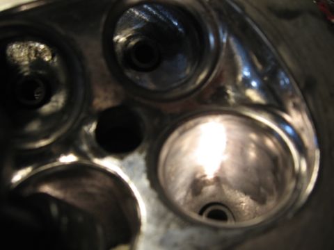 1991 Mitsubishi 3000GT - Close-up view of an engine cylinder head, showing the combustion chambers and valve seats.