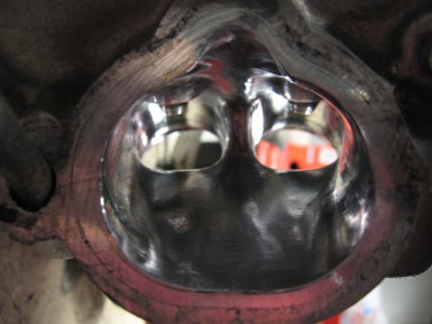 1991 Mitsubishi 3000GT - Close-up view of polished intake ports within an engine cylinder head.
