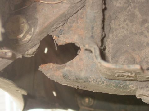 1988 Ford F-150 - Rusted frame section with a bolt, likely from an older vehicle's undercarriage.