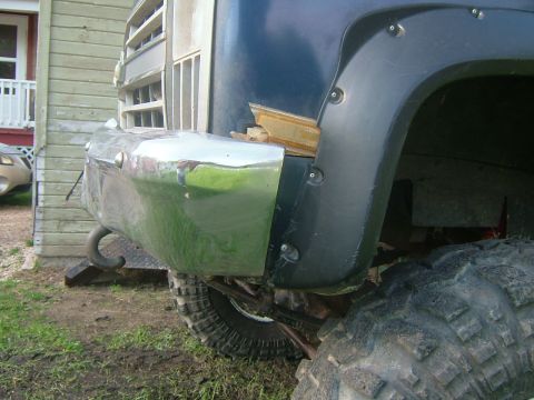 1988 Ford F-150 - This photo shows the front fender and bumper area of a truck, with large off-road tires visible.