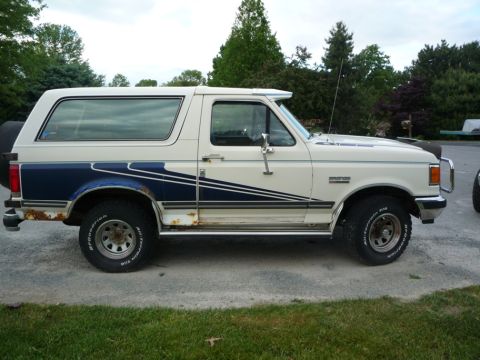 1988 Ford Bronco - This 1987 Ford Bronco shows signs of wear and tear, with visible rust on its body panels.