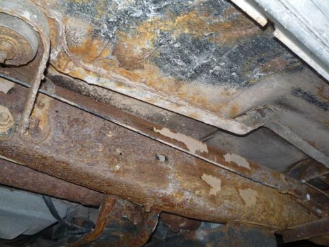1988 Ford Bronco - Undercarriage frame shows significant rust and corrosion, indicating potential structural compromise.