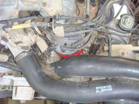 1992 Ford Bronco - Close-up of an engine bay showing various components and hoses. SuperMotors logo is present.