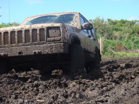 1992 Ford Bronco - This Jeep Cherokee XJ is deep in the mud, with only its front end visible above the mire.